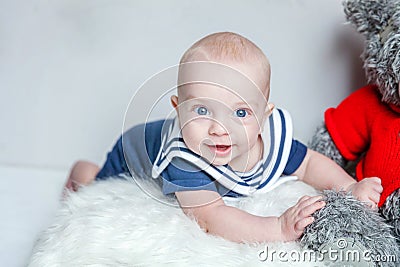 Baby sailor on the pillow with teddy bear Stock Photo