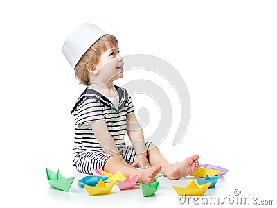 Baby sailor playing with paper boats Stock Photo
