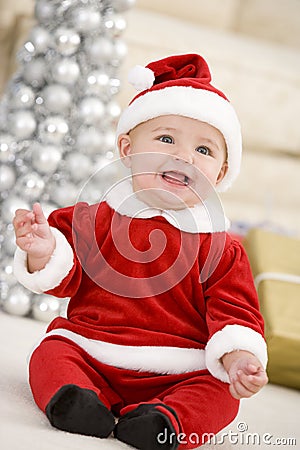 Baby In Santa Costume At Christmas Stock Photo