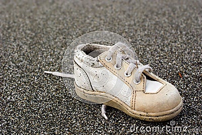 Baby Shoe on Beach Stock Photo