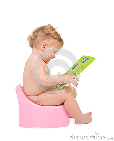 Baby sit on pink potty and look to digits toy Stock Photo