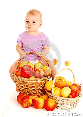 Baby sitting on apples basket Stock Photo