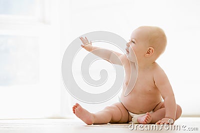 Baby sitting indoors Stock Photo