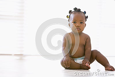 Baby sitting indoors Stock Photo