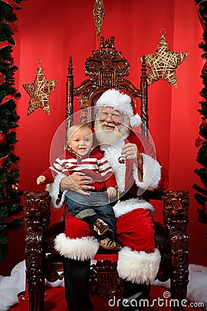 Baby Sitting on Santa's Lap Stock Photo