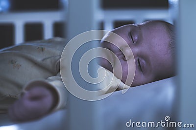 Baby sleep in a baby bed. Stock Photo