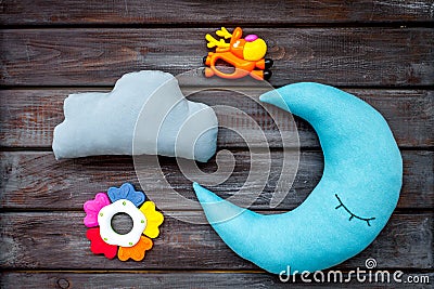 Baby sleep pattern with moon pillow, cloud and toy on wooden background top view Stock Photo