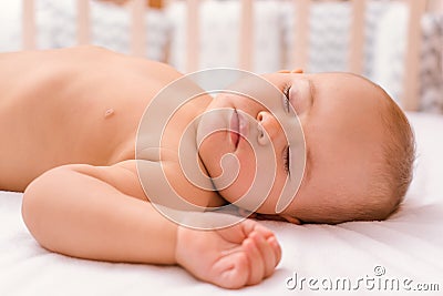 The baby is sleeping on the bed, a close-up portrait. Sleep time Stock Photo