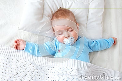 Baby sleeping on blue blanket Stock Photo