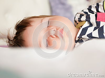 Baby sleeps in parents bed. arms outstretched baby`s restful sleep. close-up. child 0-1 years old. adorable lovely baby sleeps Stock Photo