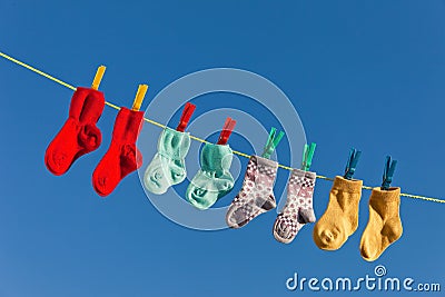 Baby socks on laundry line to dry Stock Photo