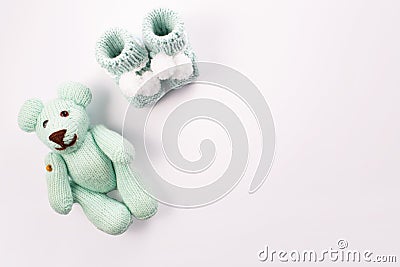 Baby socks and teddy bear on white background. Baby boy birth. Greeting card.Pregnancy announcement. Flatlay, top view Stock Photo