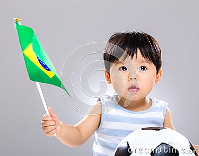 Baby son holding flag amd soccer ball Stock Photo