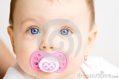 Baby with soother Stock Photo