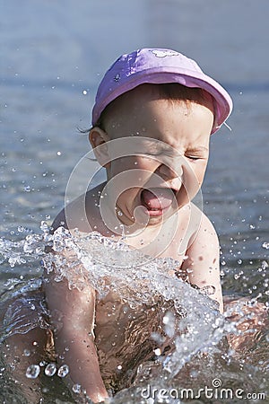 Baby splashing in water Stock Photo