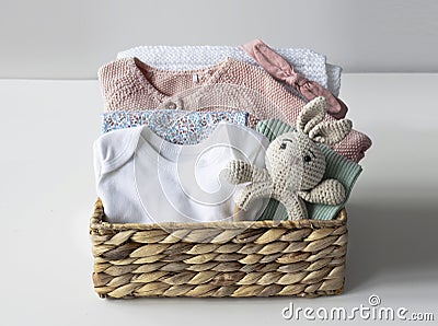 Baby stuff, infant clothes. Child closing in basket.Maternity.Newborn organic apparel Stock Photo