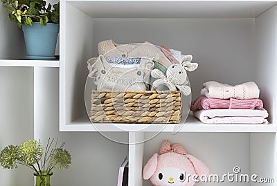 Baby stuff.Little kid apparel.Infant clothes on shelve. Stack of newborn clothing.Maternity Stock Photo