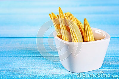 Baby sweetcorn or mini corn. It is typically the eaten whole cob included for the human consumption. It is eaten both raw and cook Stock Photo