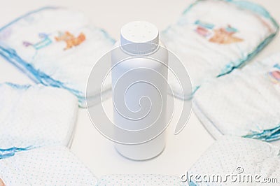 Baby talc powder bottle and diapers Stock Photo