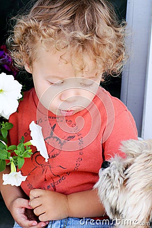 Baby talking to puppy Stock Photo