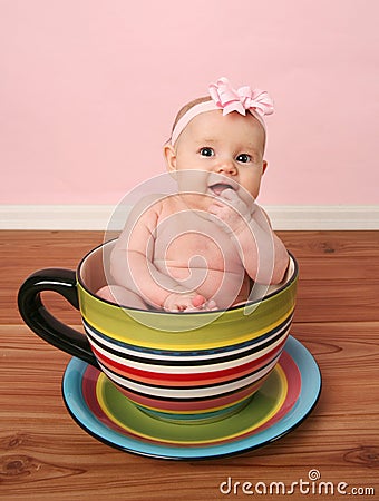 Baby in a tea cup Stock Photo