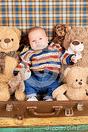 Baby, teddy bears and suitcase. Stock Photo