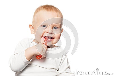 Baby teeth care. Smiling boy brushing his teeth with a toothbrush for infant. Isolated portrait Stock Photo