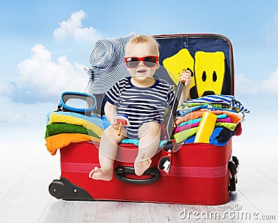 Baby in Travel Suitcase. Kid inside Luggage Packed for Vacation Stock Photo