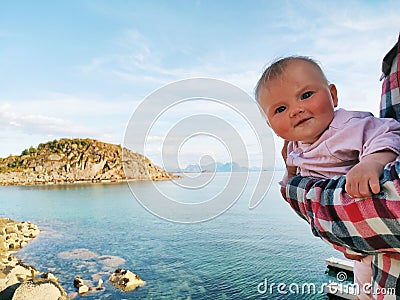 Baby traveler enjoying sea view travel family active lifestyle Stock Photo