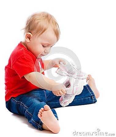 Baby trying on trainers Stock Photo