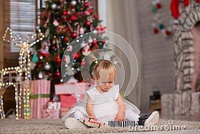 Baby year and a half waiting for Christmas Stock Photo