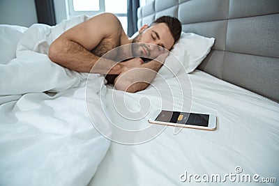 Bachelor man daily routine single lifestyle morning concept smartphone alarm clock Stock Photo
