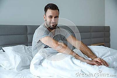 Bachelor man daily routine single lifestyle morning concept awakening stretching sleepy Stock Photo