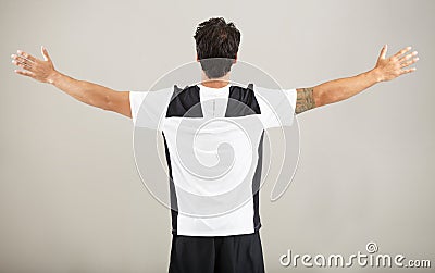 Back, athlete or man for fitness results, wellness and health isolated on grey background in studio. Arms out, model or Stock Photo