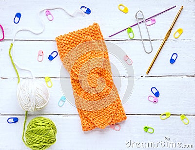 Back background for needlewomen, orange knitted headband for girls Stock Photo