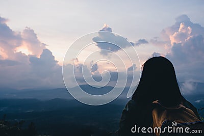 Back of backpacker looking at view in sun rise time at top of mountain.nature morning view Stock Photo
