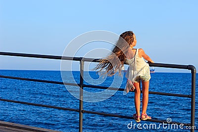 Back beautiful little Teen Girl with long flowing curly hair in Stock Photo