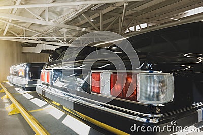 The back of a black limousine. The limousine is in the garage Stock Photo