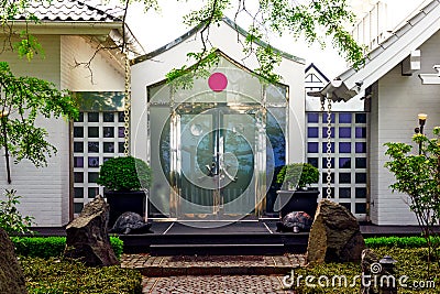 Back entrance of a white japanese style house in Timmendorf, with a red circle as stylized japanese flag Editorial Stock Photo