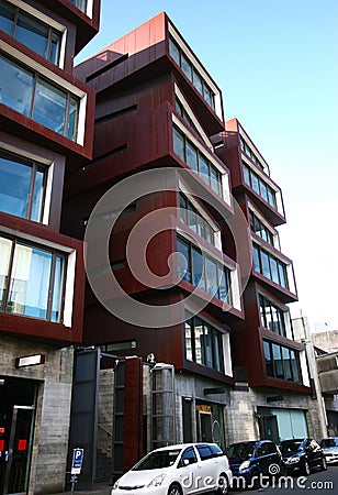 Modern rusty Ironbank with piled up boxes and glass windows. Mixed-used development on Karangahape Road, Auckland, New Zealand Stock Photo