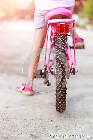 Back of girl start cycling Stock Photo