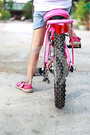 Back of girl start cycling Stock Photo