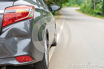 Back of gray car get damaged from accident on the road. Vehicle bumper dent broken by car crash. Road accidents and car insurance Stock Photo