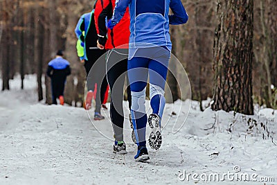 back group runners athletes running winter trail marathon Stock Photo