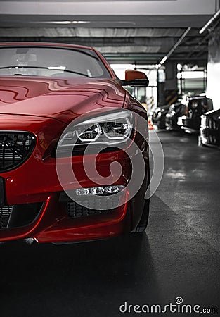 Back headlight of a modern luxury red car, auto detail, car care concept in the garage Stock Photo