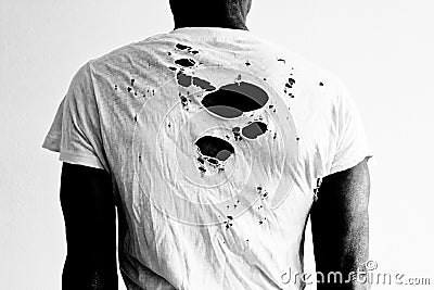 Back of a man wearing a torn white t-shirt Stock Photo
