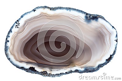 A back-lit slice of light brown concentrically layered agate Stock Photo