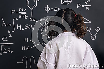 Back of a little girl science student in lab coat Stock Photo