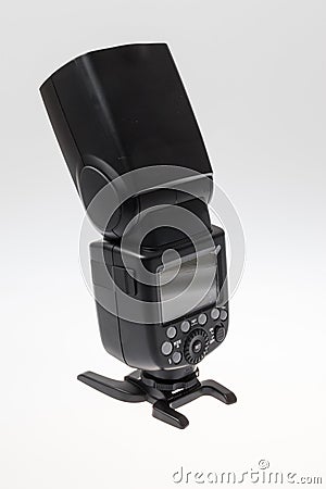 Back look of a DSLR camera speedlite flash on its stand, isolated on white background Stock Photo