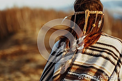 Back of native indian american woman walking in mountains in eve Stock Photo